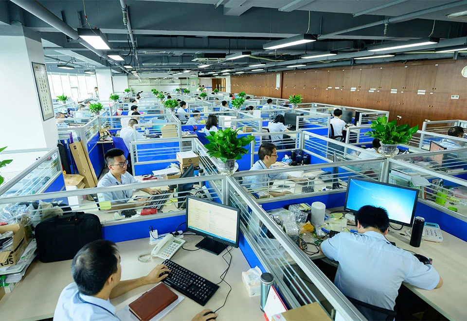 Fenda engineers working at computers and electronics workstations in an open research office.